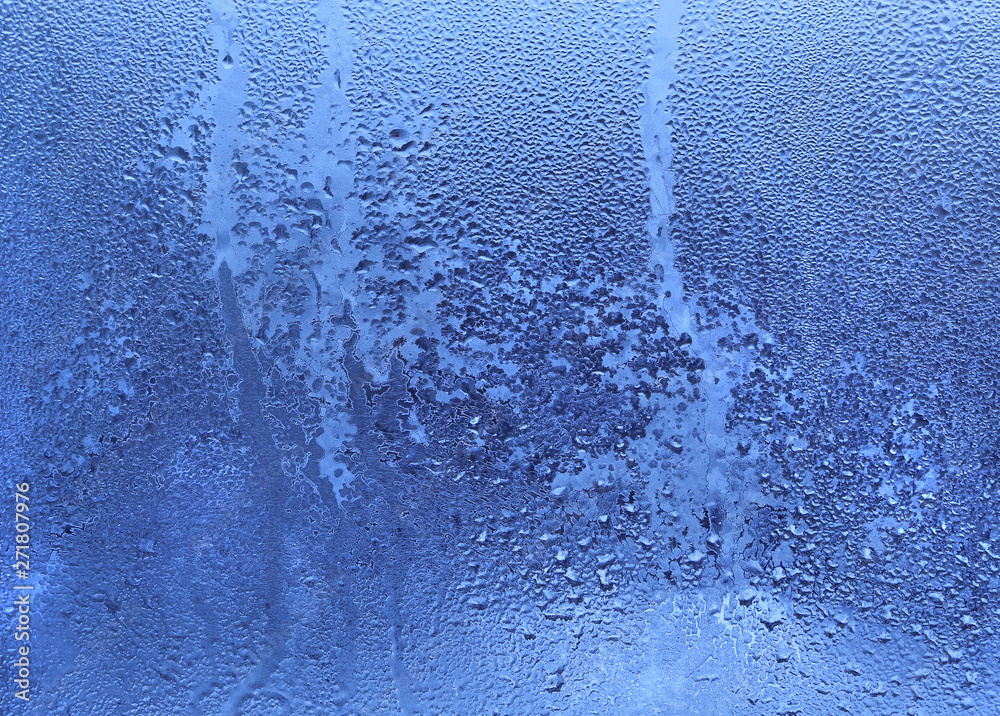 Frozen water drops on glass