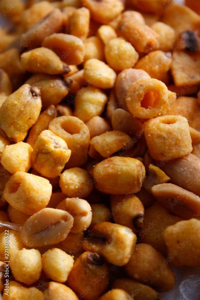 Golden mixed nuts, snacks, chips for beer close-up with selective focus. Golden mixed nuts, snacks, chips for beer close-up with selective focus.