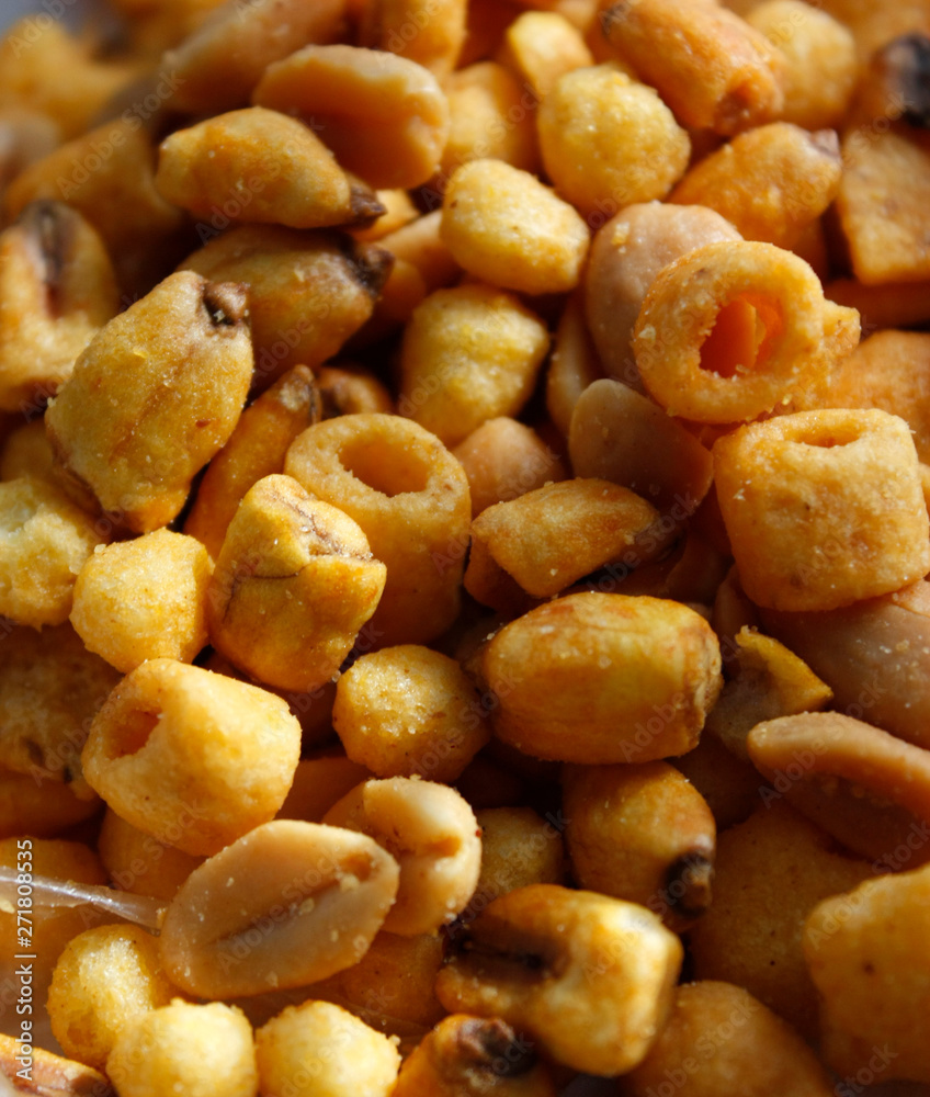 Golden mixed nuts, snacks, chips for beer close-up with selective focus. Golden mixed nuts, snacks, chips for beer close-up with selective focus.