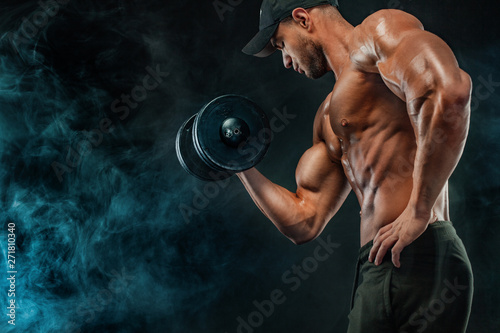 Muscular fitness sports man, atlete with dumbbell in fitness gym.