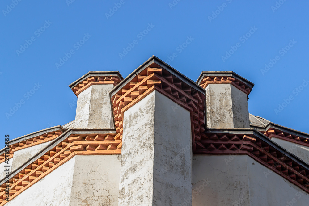 Bottom shoot of masonry structure mosque with oriental ordered bricks under roof at noon time