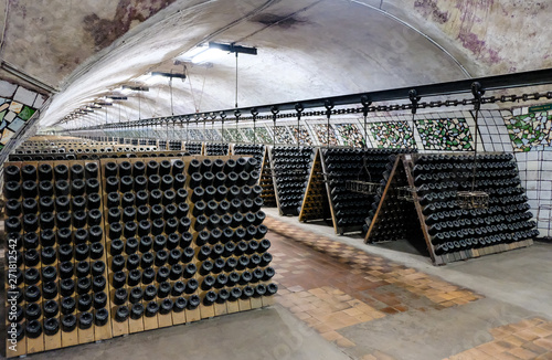 Wine bottles in the cellar. Wine cellar at the factory.
