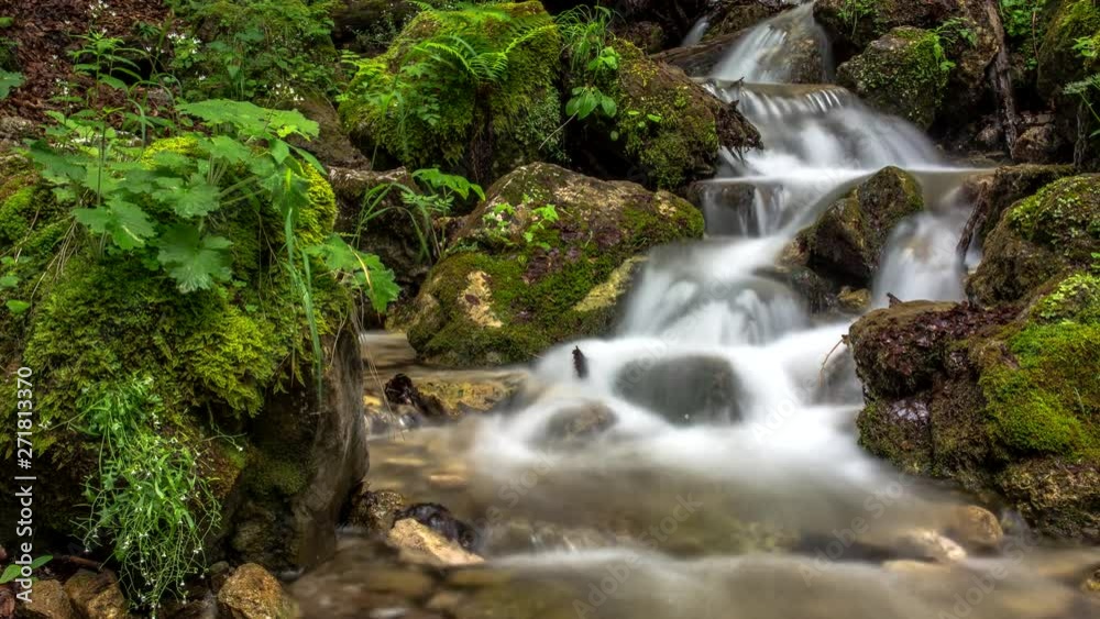 Mountain stream waterfall between rocks deep in the forest 4k time lapse Mountain stream waterfall between rocks deep in the forest 4k time lapse