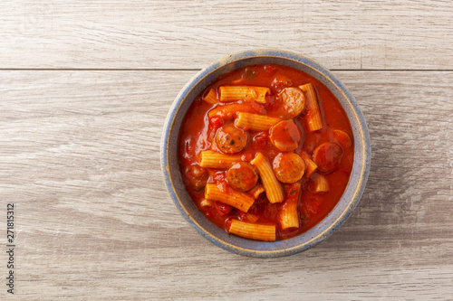 Slika na platnu Sausage rotini in a stoneware bowl top view