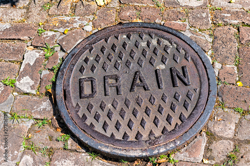 New Orleans, USA Garden district street in Louisiana famous city with drain hole on sidewalk pavement road photo