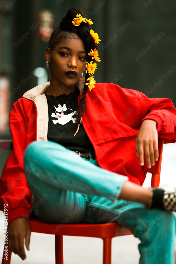 sitting woman in red jacket and blue pants Stock Photo | Adobe Stock