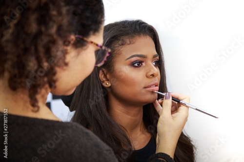 selective focus photography of woman holding paintbrush photo