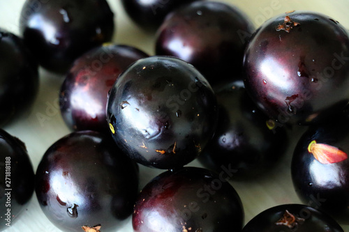 Jabuticaba or Jaboticaba is a purplish-black  white-pulped fruit that can be eaten raw or be used to make jellies  juice or wine.