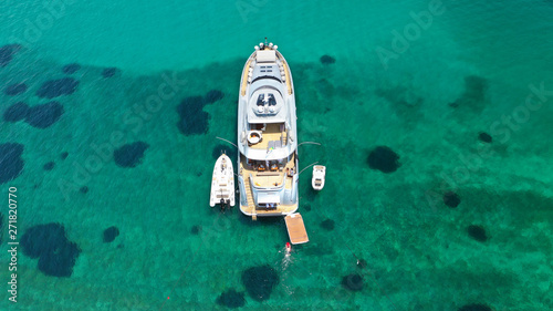 Aerial drone top view photo of large yacht - boat docked in tropical exotic paradise bay with emerald open ocean