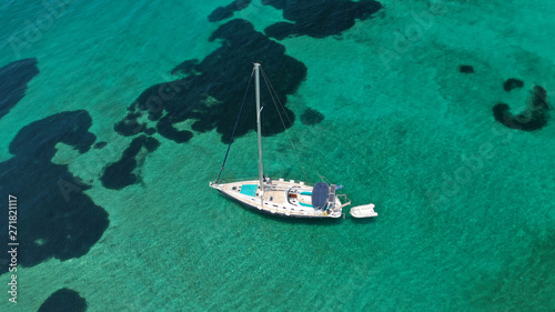 Aerial drone top view photo of sail boat docked in tropical exotic bay with emerald calm sea © aerial-drone