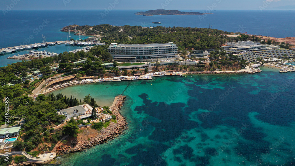 Obraz premium Aerial drone bird's eye panoramic photo of famous celebrity sandy beach of Astir or Asteras in south Athens riviera with turquoise clear waters, Vouliagmeni, Greece