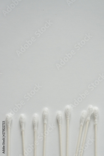Q-tip, or cotton bud swab top view on vertical white background with blank empty space for copy or text; Features best health care hygiene practices to clean ear.