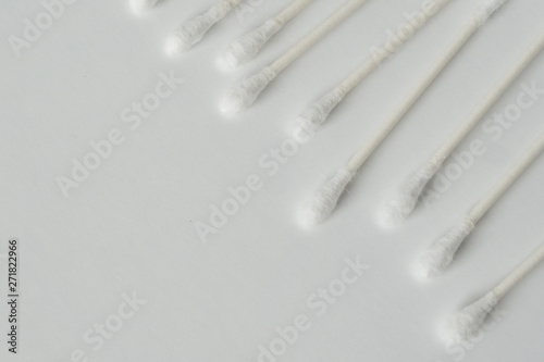 Q-tip, or cotton bud swab top view on white background with horizontal blank empty space for copy or text; Features best health care hygiene practices to clean ear.
