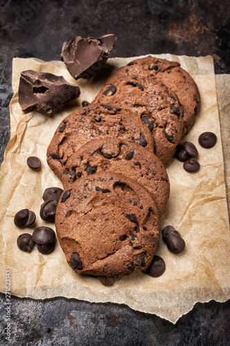 Chocolate chip cookies on rusty metal baking sheet