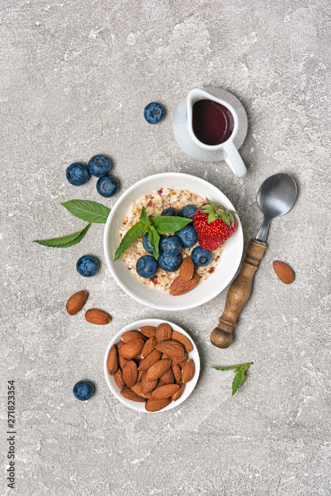 Healthy breakfast - homemade oatmeal with fresh berries and almond