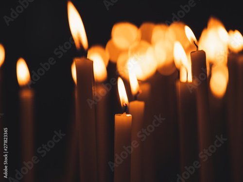 Image of many burning candles with shallow depth of field photo