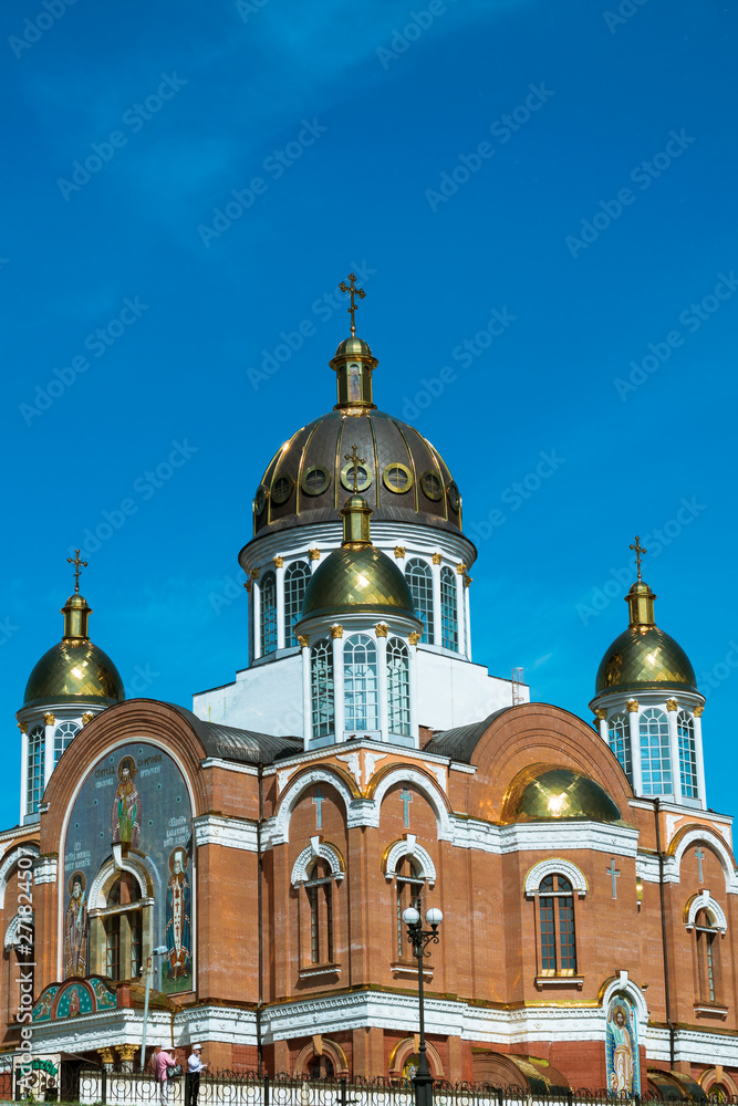 Cathedral against the blue sky. Cathedral with golden domes. St. Pokrovsky Cathedral