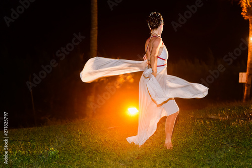 girl in a dancing dress, woman dancing in the garden at night, woman in white dress, woman twirling