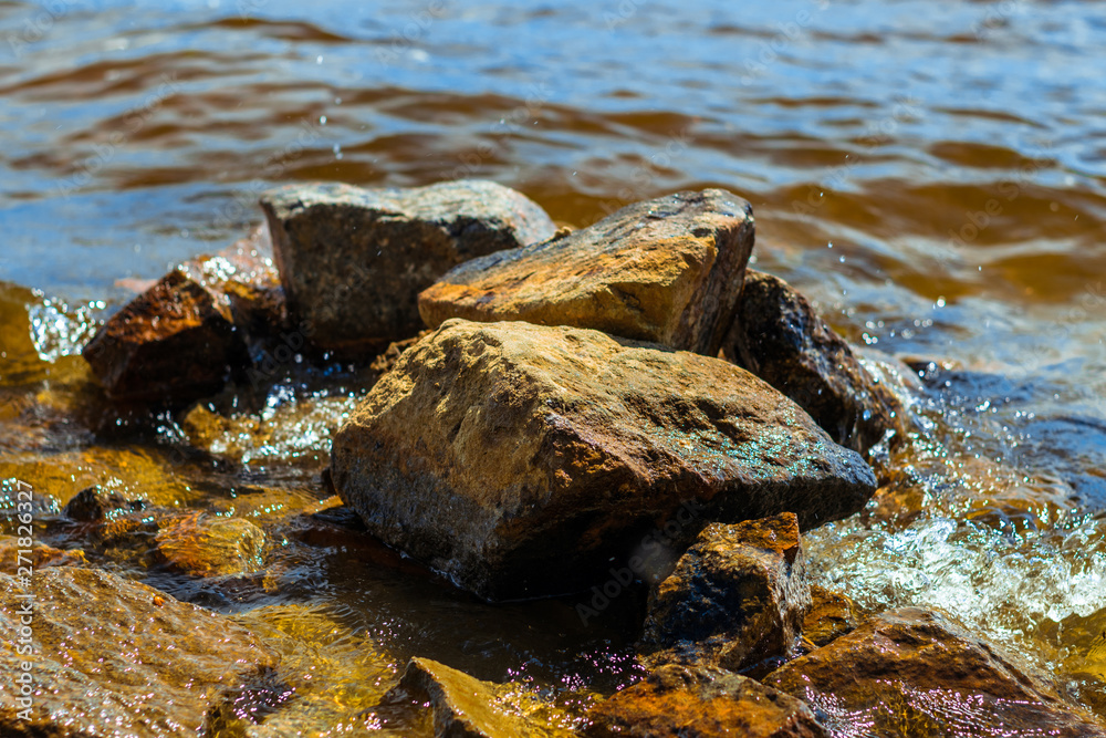 Red stones on the beach. Stones washed by the waves Red stones on the beach. Stones washed by the waves