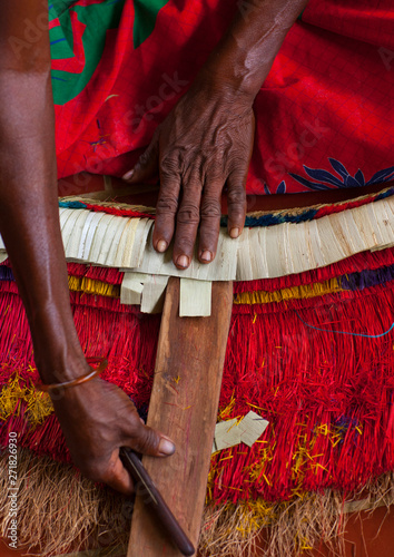 Woman Making A Traditional Skirt, Trobriand Island, Papua New Guinea photo