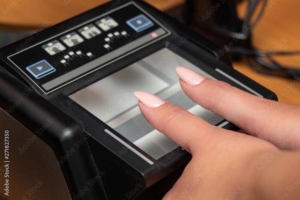 The process of scanning fingerprints during the check at border