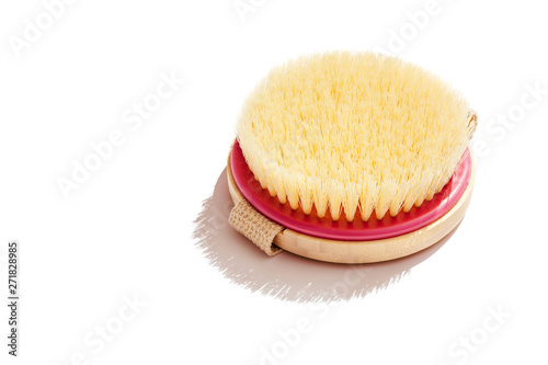 Dry body massage brush on white background at sunny day. Tool for smooth and soft skin. Copy space.