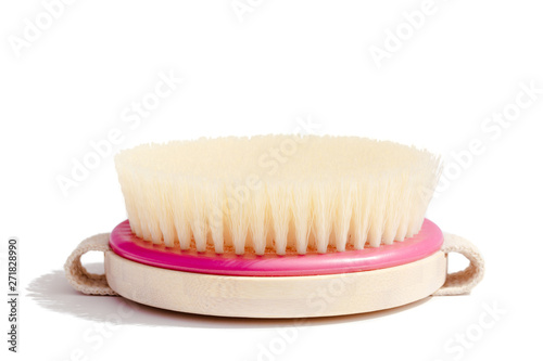 Dry body massage brush on white background at sunny day. Tool for smooth and soft skin. Place for text.