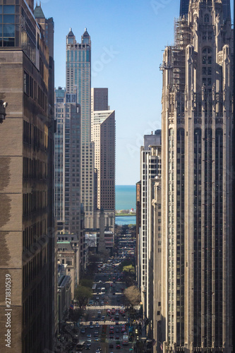 Chicago skyscrapers line the fabulous Michigan Ave, "Magnificent Mile". View of Michigan Ave and Lake Michigan seen from high-rise building.