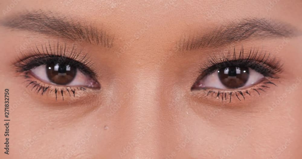 Close-up woman eye at white background looking to camera. Close-up woman eye at white background looking to camera.