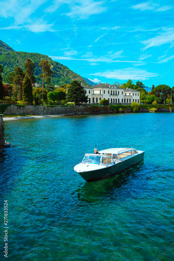 Yacht on the clear turquoise water of a mountain lake