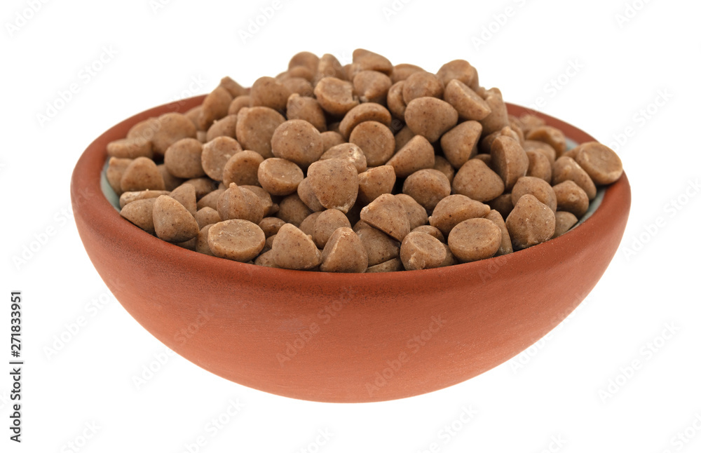 Cinnamon baking chips in a small bowl side view Cinnamon baking chips in a small bowl side view
