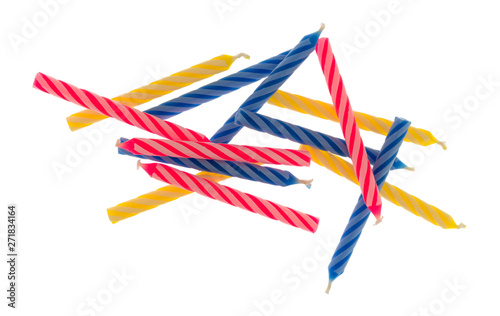 Group of blue pink and yellow spiral birthday candles on a white background