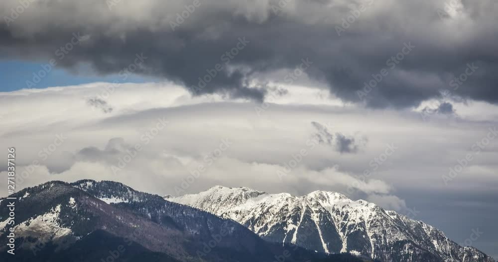 Time lapse of large clouds moving over the snow covered mountains and hills. Time lapse of large clouds moving over the snow covered mountains and hills.
