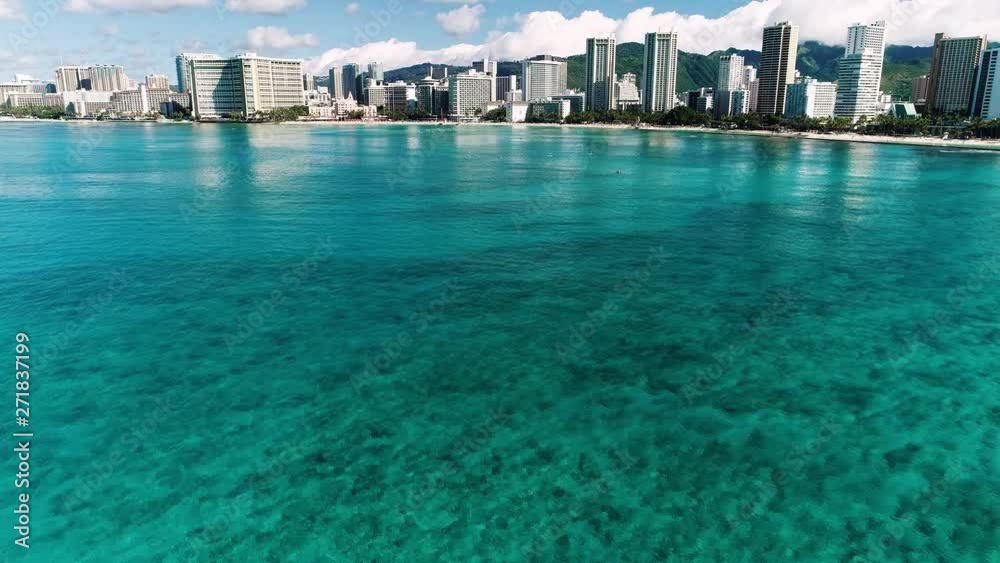 Flying over clear blue water towards Waikiki beach in Honolulu. Flying over clear blue water towards Waikiki beach in Honolulu.