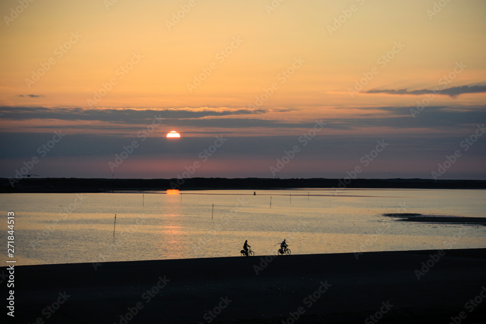 Dutch people riding a bike - beautiful sunset