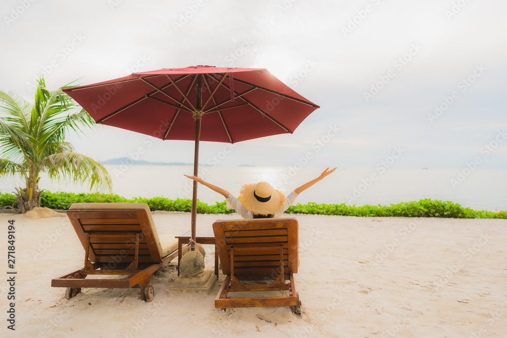 Portrait beautiful asian woman wear hat with smile happy leisure on the beach sea ocean in holiday vacation