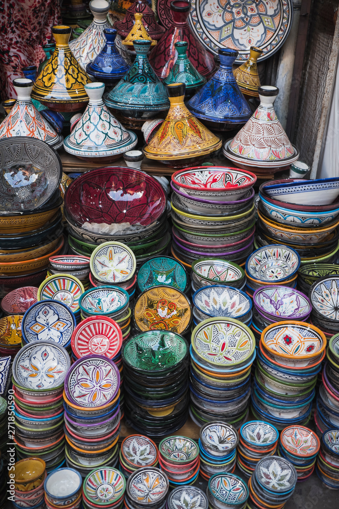 Colorful bowls and tagines at a market in marrakech, morocco