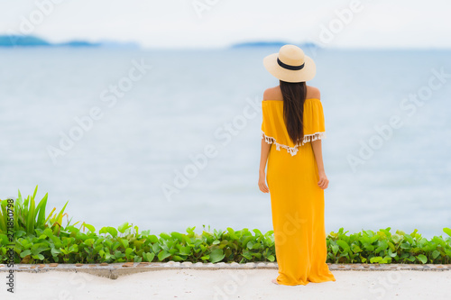 Portrait beautiful asian woman wear hat with smile happy leisure on the beach and sea in holiday vacation © siraphol
