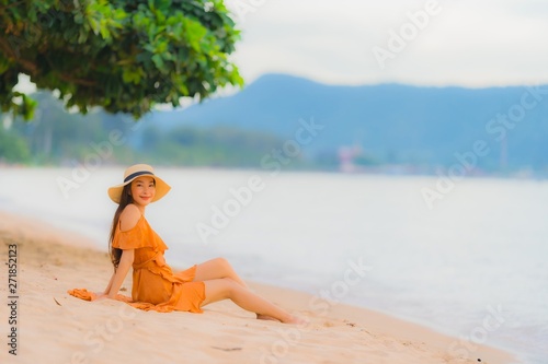 Portrait beautiful young asian woman happy smile relax on the beach sea ocean