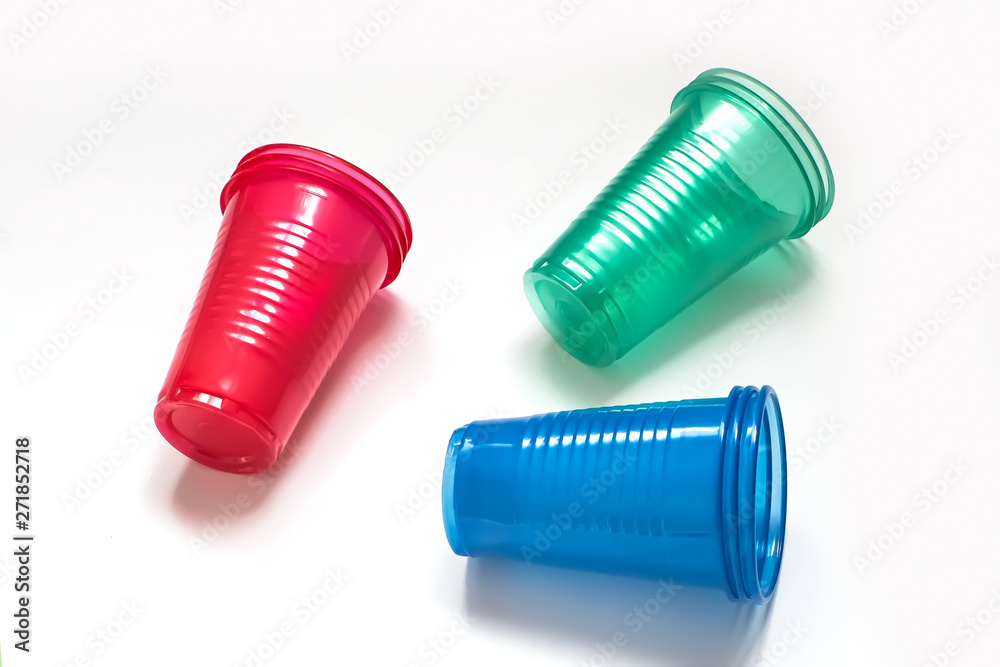Bright colourful disposable plastic cups isolated on white background. Ecology problem. Copy space. Bright colourful disposable plastic cups isolated on white background. Ecology problem. Copy space.