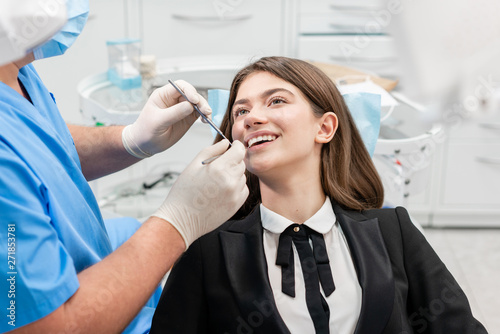 Fototapeta Naklejka Na Ścianę i Meble -  Doctor treats teeth. Medicine, health, stomatology concept. dentist treating a patient. . Young beautiful woman in the dentist chair at dental clinic.