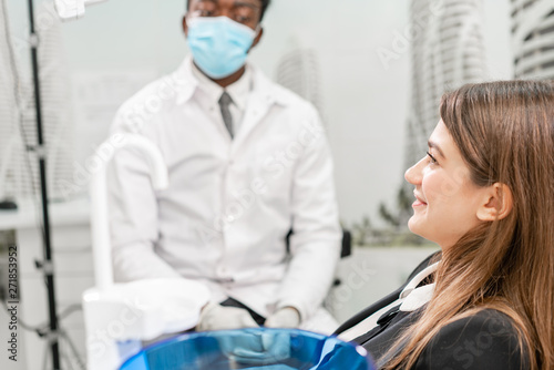 young beautiful girl in the dentist chair at dental clinic. Medicine  health  stomatology concept. dentist treating a patient. Woman smiling