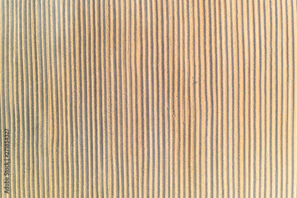 Vertical lines on sand, texture concept. Farming pattern Vertical lines on sand, texture concept. Farming pattern