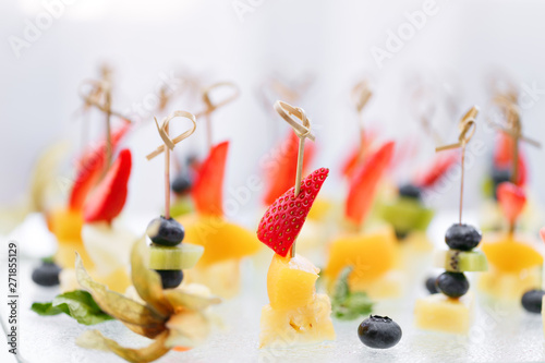 Buffet at the gala dinner. Canapes with cheese, pineapple and strawberries. Assortment of canapes. Banquet service. catering food