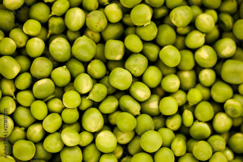 The background is green peas. © evgenii