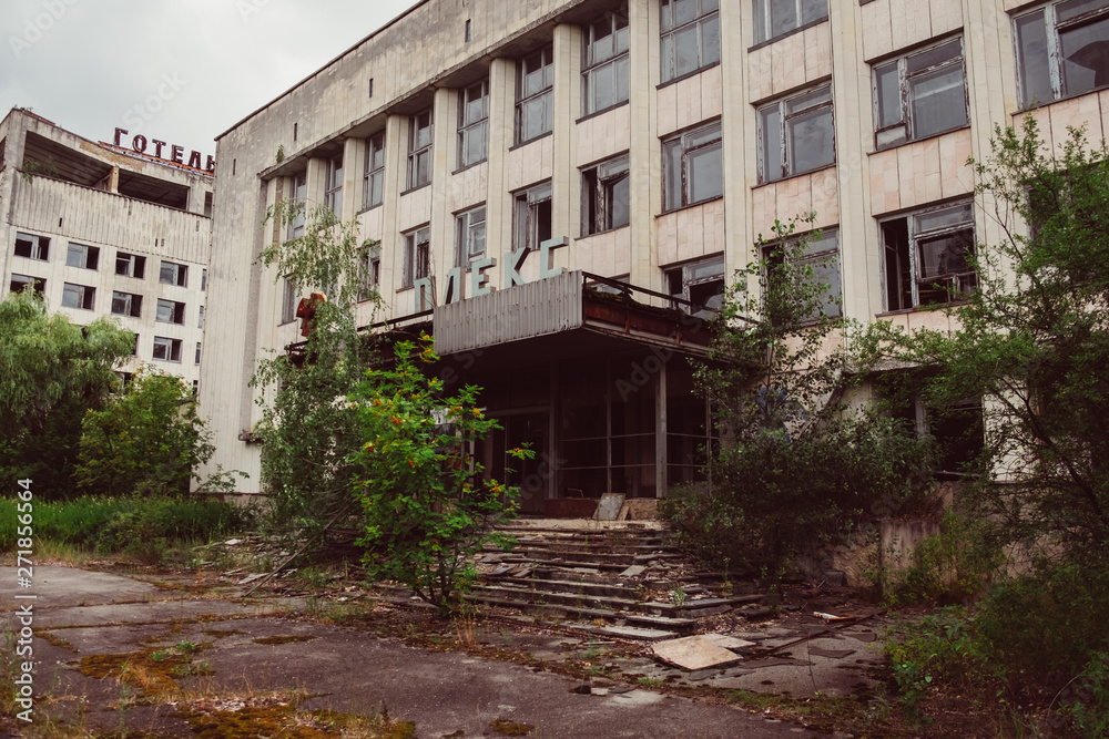 Chernobyl Exclusion Zone, Ukraine. Destroyed abandoned ghost city Pripyat ruins after disaster. Nuclear Power Plant atomic reactor sign. Lost town. Text translation: hotel complex.