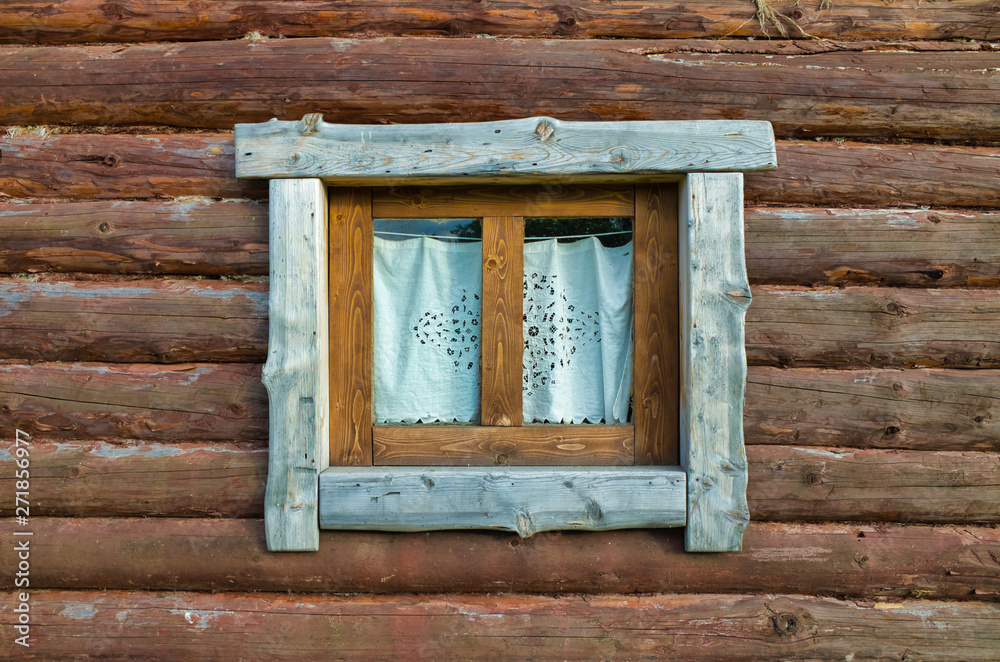 View of the window of a wooden hut View of the window of a wooden hut