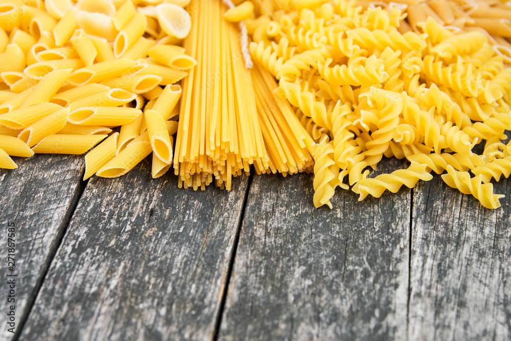 composition of raw pasta different shapes, frame of raw pasta. room for text composition of raw pasta different shapes, frame of raw pasta. room for text