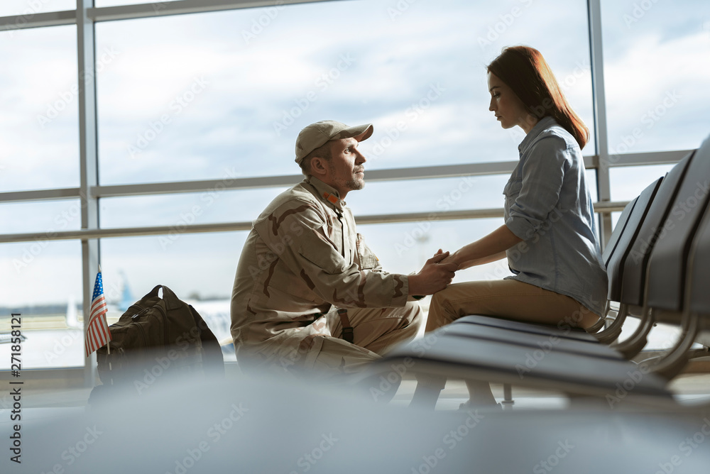 Soldier situating opposite his spouse and promising to come back home alive Soldier situating opposite his spouse and promising to come back home alive