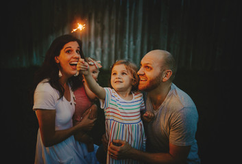 Happy Family doing sparkler fireworks together